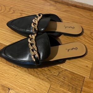 Black mules with gold detailing